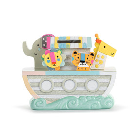 Front facing view of a ceramic piggy bank. The bank is a figure of Noah's Ark with several animals on the deck.