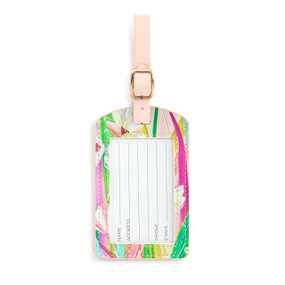 Front facing view of a floral luggage tag, showing the opening with the ID information card. The pale pink strap is at the top.