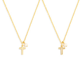 Detail view of two matching gold necklaces with cross and single pearl pendants.