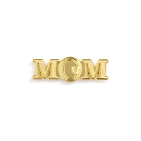 Top down view of a gold magnet shaped as the word "Mom". There is a heart on the right side of the letter O.