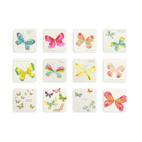 Top down view of an assortment of twelve square magnets, arranged in a four by three grid. Each magnet has an image of one or several colorful butterflies on a white background.