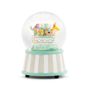 Front view of a musical snow globe. The base of the globe is tan and white striped with light green trim at the top and bottom. Inside the globe is a Noah's Ark figurine with a few animals on the deck.