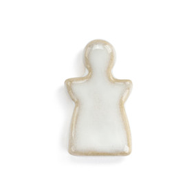 Top down view of a small white angel shaped ceramic token.