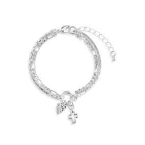 Top down view of a silver layered bracelet with heart and cross charms. The bracelet's layers are made of two chains of different thickness. The double heart charm is at the bottom of the image. The clasp and extender chain are at the top.