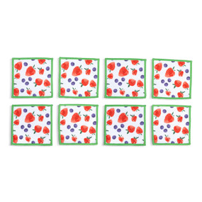 Top down view of four fabric napkins printed with strawberries and blueberries on a white background and green edging, The napkins are arranged in a 2x2 grid and tilted to the left.