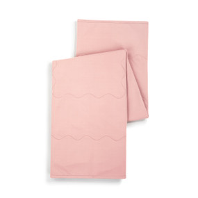 Top down view of a coral pink weighted lap blanket, folded in a vertical zig-zag.