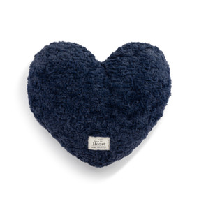 Top down view of a blue heart shaped weighted pillow. A patch at the bottom of the heart, reads "A hug from the heart."