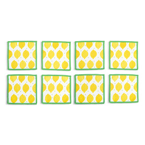 Top down view of four fabric napkins with a large lemon print and green edging, The napkins are arranged in a 2x2 grid and tilted to the left.