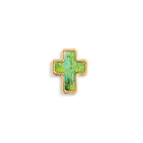 Top down view of a gold cross shaped pin. The surface of the cross is a scene of trees and bushes against a blue sky with gold edging.