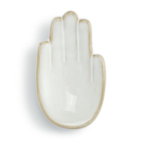 Top down view of a white ceramic trinket dish. The dish is a palm up right hand.