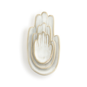 Front view of a wall art piece. The figure is of three right hands nested together, palm up, with the smallest on top.