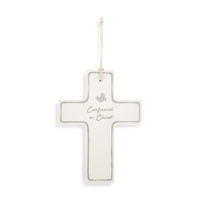 Front view of a white ceramic cross, with a cord for hanging threaded through a small hole in the top. The edges of the cross are outlined in grey. The words "Confirmed in Christ" are written in grey script at the center, with a small grey dove directly above.