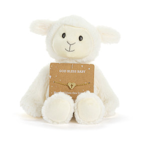 Front facing view of a white plush lamb with a card on its lap. The card holds a gold bracelet with a heart charm that has a cross cutout at its center. "God bless baby" is printed on the card above the bracelet.