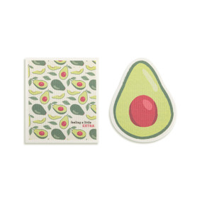 Top down view of a set of biodegradable dish towels set side by side. The towel on the right is shaped like a halved avocado. The towel on the left is rectangular and has a print of avocados on a white background.