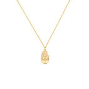 Detail view of a gold chain necklace and pendant. The pendant is a right hand, palm up, with a heart in the center of the palm.