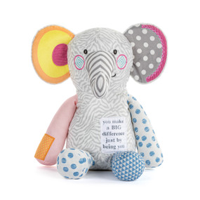 Front view of a plush elephant with a packaging tag. The elephant's body is mostly gray, with a patch on its lower right chest that reads "You make a big difference just by being you". The trunk is gray and white striped. The elephant's limbs and ears are different colors and patterns.