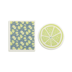 Top down view of a set of biodegradable dish towels set side by side. The towel on the right is shaped like a slice of lime. The towel on the left is rectangular and has a print of limes on a gray background.