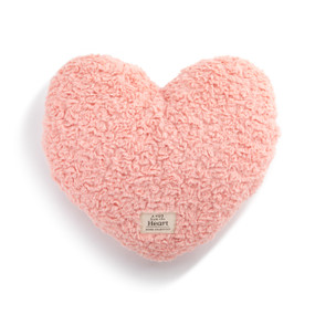 Top down view of a pink heart shaped weighted pillow. A patch at the bottom of the heart reads "A Hug from the heart."