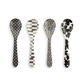 Top down view of a set of four melamine spoons in packaging. Each spoon is a different color and pattern, unified with the colors black, white and gray.