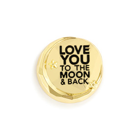 Top down view of a circular gold magnet with a crescent moon around the edge and the words "Love you to the moon & back".