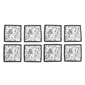 Top down view of four fabric napkins with black line drawings of flowers on a white background with black edging, The napkins are arranged in a 2x2 grid and tilted to the left.