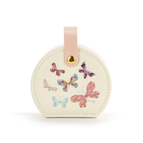 Front facing view of a circular white traveling jewelry case with several multicolored butterflies on the lid. The pink strap is snapped at the top, holding the case closed.