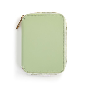 Top down view of the front of a sage green passport wallet. The wallet is zipped closed, with the zipper pull on the wallet's upper left side.