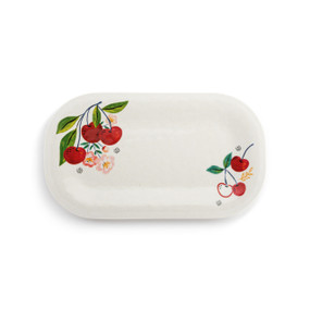 Top down view a rectangular melamine platter, decorated with cherries and leaves in the upper left and lower right corners.