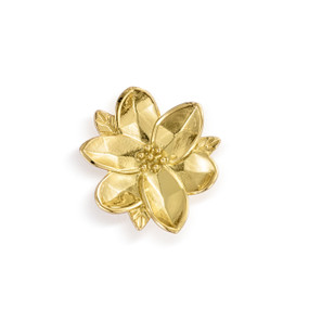 Top down view of a gold sculpted flower magnet.