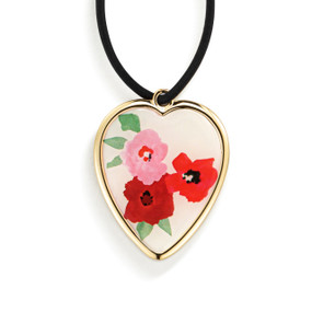 Top down view of the front of a heart shaped gift tag for a wine bottle, strung with a black cord. The heart has an image of red and pink poppies on a white background.