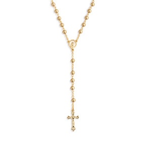 Detail view of the centerpiece and pendant of a gold rosary with gold beads and gold crucifix.