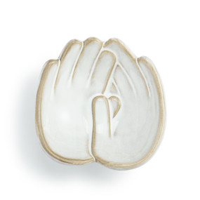 Top down view of a white ceramic trinket dish. The dish is two hands side by side, palm up, forming a shallow bowl.