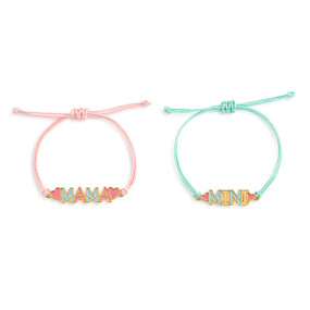 Top down view of a pair of adjustable cord bracelets. The bracelet on the left has a pink cord, and a charm of the word "Mama." The bracelet on the left has a blue cord, and a charm of the word "Mini".