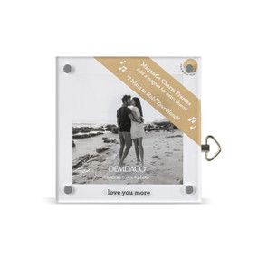 Top down view of a square acrylic musical frame with magnets in each corner. "Love you more" is printed at the bottom. A brown banner in the upper right corner indicates the music box plays "I Want To Hold Your Hand".