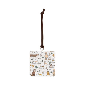 Front view of a square white ornament strung with a black cord for hanging, with several small illustrations of different breeds of dogs.