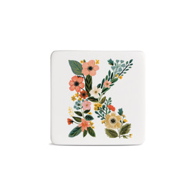 Front view of a square white magnet monogrammed with the letter K. The letter is former with a design of orange flowers and green leaves.