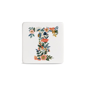 Front view of a square white magnet monogrammed with the letter T. The letter is former with a design of orange flowers and green leaves.