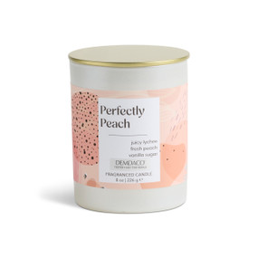 An 8 oz tester perfectly peach scented candle in a round white container with a gold lid.