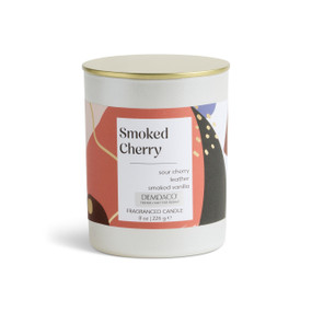 An 8 oz tester smoked cherry scented candle in a round white container with a gold lid.