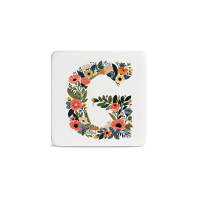 Front view of a square white magnet monogrammed with the letter G. The letter is former with a design of orange flowers and green leaves.