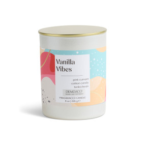 An 8 oz tester vanilla vibes scented candle in a round white container with a gold lid.