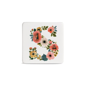 Front view of a square white magnet monogrammed with the letter S. The letter is former with a design of orange flowers and green leaves.