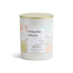 An 8 oz tester pistachio dream scented candle in a round white container with a gold lid.