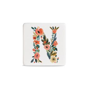 Front view of a square white magnet monogrammed with the letter N. The letter is former with a design of orange flowers and green leaves.