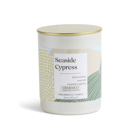 An 8 oz tester seaside cypress scented candle in a round white container with a gold lid.