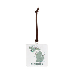 Front view of a white square ornament strung with a black cord for hanging with an illustrated map of Michigan with landmarks and cities.