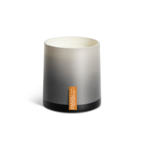 A Himalayan Citrus poured tester candle in an ombre gray glass vessel.