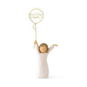 Front view: standing figure in cream dress, arms raised, holding gold wire balloon with 2025 written in gold wire inside
