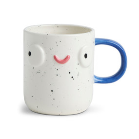 Front facing view of a white speckled character mug. The mug's blue handle is to the right. The mug is named Carey Blue Lefty and has a smiling face on his front.