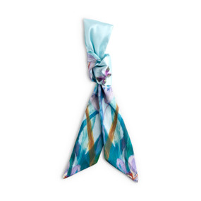 Top down view of a skinny tie style scarf for bags. The scarf is displayed doubled over and tied with a knot at the center. One side of the scarf has a floral print with blue accents. The other side has a print of small butterflies on a solid light blue background.